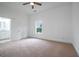 Spacious bedroom featuring a window, door to bathroom, ceiling fan, and neutral carpeting at 1993 Reynolds Sw Dr, Atlanta, GA 30315