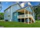 Rear exterior of a two-story home featuring a covered porch with ceiling fan and access stairs at 1993 Reynolds Sw Dr, Atlanta, GA 30315