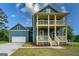 New construction features a double porch, well-manicured lawn and an attached garage at 1993 Reynolds Sw Dr, Atlanta, GA 30315