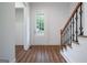 Bright foyer with wood floors, a staircase, and a front door view to the exterior at 1993 Reynolds Sw Dr, Atlanta, GA 30315