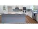 Beautiful kitchen featuring white cabinets, stainless steel appliances, and a large gray island with marble countertop at 1993 Reynolds Sw Dr, Atlanta, GA 30315