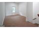 Carpeted living room with access to outside and stairs to the second floor at 1993 Reynolds Sw Dr, Atlanta, GA 30315