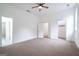 Spacious main bedroom with plush carpet, ceiling fan and a view into the bathroom at 1993 Reynolds Sw Dr, Atlanta, GA 30315