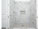Marble tiled shower with a built-in niche and glass door at 1993 Reynolds Sw Dr, Atlanta, GA 30315