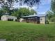 Spacious backyard featuring a large deck, a detached garage, and a lush lawn surrounded by trees at 5761 Hancock Dr, Social Circle, GA 30025