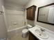 Bathroom featuring a shower and bathtub combo, a vanity with a sink, and a storage cabinet at 5761 Hancock Dr, Social Circle, GA 30025
