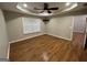 Bright bedroom featuring hardwood floors, ceiling fan, and natural light at 5761 Hancock Dr, Social Circle, GA 30025
