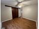 Bedroom featuring wood floors and barn door closet at 5761 Hancock Dr, Social Circle, GA 30025