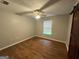 Bright bedroom featuring wood flooring, neutral paint, and ceiling fan at 5761 Hancock Dr, Social Circle, GA 30025