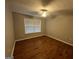 Bedroom featuring hardwood floors, neutral walls, and a ceiling fan with a window at 5761 Hancock Dr, Social Circle, GA 30025