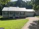 Charming home with a well-manicured front lawn and attached garage at 5761 Hancock Dr, Social Circle, GA 30025