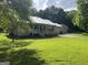 Single story home with metal roof, covered porch, attached garage, and well maintained lawn at 5761 Hancock Dr, Social Circle, GA 30025