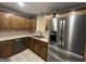 Updated kitchen featuring stainless steel appliances and wood cabinets at 5761 Hancock Dr, Social Circle, GA 30025
