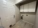 Laundry room with tile floors and cabinet storage space at 5761 Hancock Dr, Social Circle, GA 30025