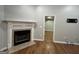 Living room with a fireplace, wood flooring, and neutral paint at 5761 Hancock Dr, Social Circle, GA 30025