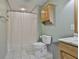 Bathroom featuring a tiled shower, toilet, and wood vanity cabinet at 125 Drennan Dr, Fayetteville, GA 30215