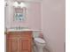 Powder room featuring wood vanity with marble countertop, mosaic mirror, and toilet at 125 Drennan Dr, Fayetteville, GA 30215
