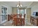 Dining room with wood table and chairs, decorative chandelier, and bay windows at 125 Drennan Dr, Fayetteville, GA 30215