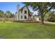 Exterior view of the home featuring a large tree, stone accents, and an attached garage at 125 Drennan Dr, Fayetteville, GA 30215