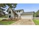 Charming two-story home featuring a stone accent wall, attached two-car garage, and inviting front porch at 125 Drennan Dr, Fayetteville, GA 30215