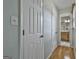 Hallway that leads to the bathroom; neutral walls and wood flooring present at 125 Drennan Dr, Fayetteville, GA 30215