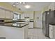 Bright kitchen features white cabinets, dark countertops, and stainless steel appliances at 125 Drennan Dr, Fayetteville, GA 30215