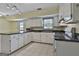 Bright kitchen with white cabinets, black countertops, and a breakfast bar at 125 Drennan Dr, Fayetteville, GA 30215