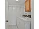 Well-lit laundry room featuring a washer and dryer, plus built-in shelving at 125 Drennan Dr, Fayetteville, GA 30215