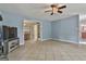 Open-concept living room featuring blue walls, tile floors, and a ceiling fan at 125 Drennan Dr, Fayetteville, GA 30215