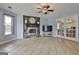 Bright living room featuring a stone fireplace, tile flooring, and French doors to the dining room at 125 Drennan Dr, Fayetteville, GA 30215