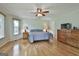 Main bedroom featuring hardwood floors, ceiling fan, and natural light from large windows at 125 Drennan Dr, Fayetteville, GA 30215