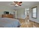 Spacious main bedroom featuring wood floors, ceiling fan, and ensuite bathroom access at 125 Drennan Dr, Fayetteville, GA 30215