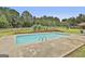 Backyard in-ground swimming pool surrounded by a concrete patio and lush green lawn at 125 Drennan Dr, Fayetteville, GA 30215