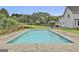 Backyard in-ground swimming pool surrounded by a concrete patio and lush green lawn at 125 Drennan Dr, Fayetteville, GA 30215