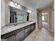 Modern bathroom featuring double vanity with granite countertop and a large mirror at 473 Cherry Creek Dr, Loganville, GA 30052