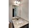 Bathroom vanity featuring a granite countertop, white sink, large mirror and modern lighting at 473 Cherry Creek Dr, Loganville, GA 30052