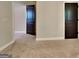 Bedroom displaying a neutral carpet and a dark wooden door that accentuates the walls and trim at 473 Cherry Creek Dr, Loganville, GA 30052