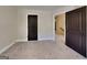 Bedroom displaying a neutral carpet and a dark wooden door that accentuates the walls and trim at 473 Cherry Creek Dr, Loganville, GA 30052