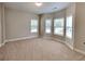 Spacious bedroom with tan walls, plush carpeting, and large windows for natural light at 473 Cherry Creek Dr, Loganville, GA 30052