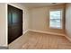 Bedroom showcasing a neutral carpet, large window letting in natural light, and a dark wooden door at 473 Cherry Creek Dr, Loganville, GA 30052