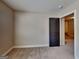Bedroom displaying a neutral carpet and a dark wooden door that accentuates the walls and trim at 473 Cherry Creek Dr, Loganville, GA 30052