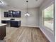 Bright dining area features stainless steel appliances, dark cabinets, and a window with natural light at 473 Cherry Creek Dr, Loganville, GA 30052