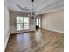 Open dining room with hardwood floors, stylish light fixture, and large window at 473 Cherry Creek Dr, Loganville, GA 30052