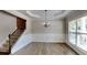Elegant dining room includes modern wainscoting, a tray ceiling, and staircase leading to the upper level at 473 Cherry Creek Dr, Loganville, GA 30052