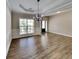 Formal dining room showcasing a tray ceiling, elegant chandelier, and large windows for ample natural light at 473 Cherry Creek Dr, Loganville, GA 30052