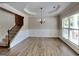 Elegant dining room boasting decorative wainscoting, vinyl flooring, and a stylish chandelier fixture at 473 Cherry Creek Dr, Loganville, GA 30052