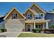 Charming two-story home with gabled roof, shutters and a well-manicured front yard at 473 Cherry Creek Dr, Loganville, GA 30052