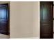 Hallway with a smooth white wall and two wooden doors at either side of the shot at 473 Cherry Creek Dr, Loganville, GA 30052