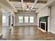 Spacious living room featuring a modern fireplace, coffered ceilings, neutral tones, and ample natural light at 473 Cherry Creek Dr, Loganville, GA 30052