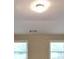 Bright living room featuring a modern light fixture, neutral paint and large windows letting in natural light at 473 Cherry Creek Dr, Loganville, GA 30052